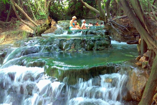 A riverboat moving through a dense South American rainforest.